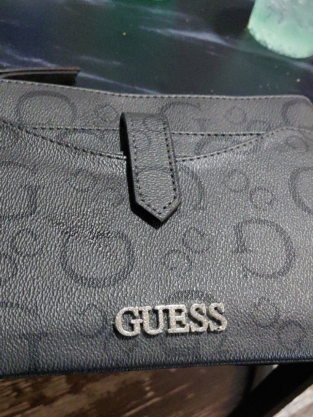 his GUESS logo-patterned clutch or wristlet features a dark gray faux leather co